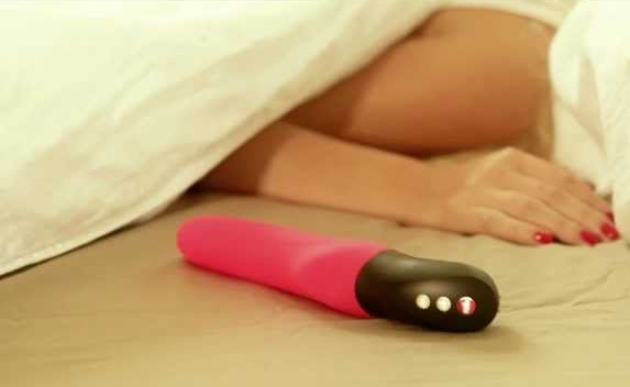 woman in bed with thrusting vibrator